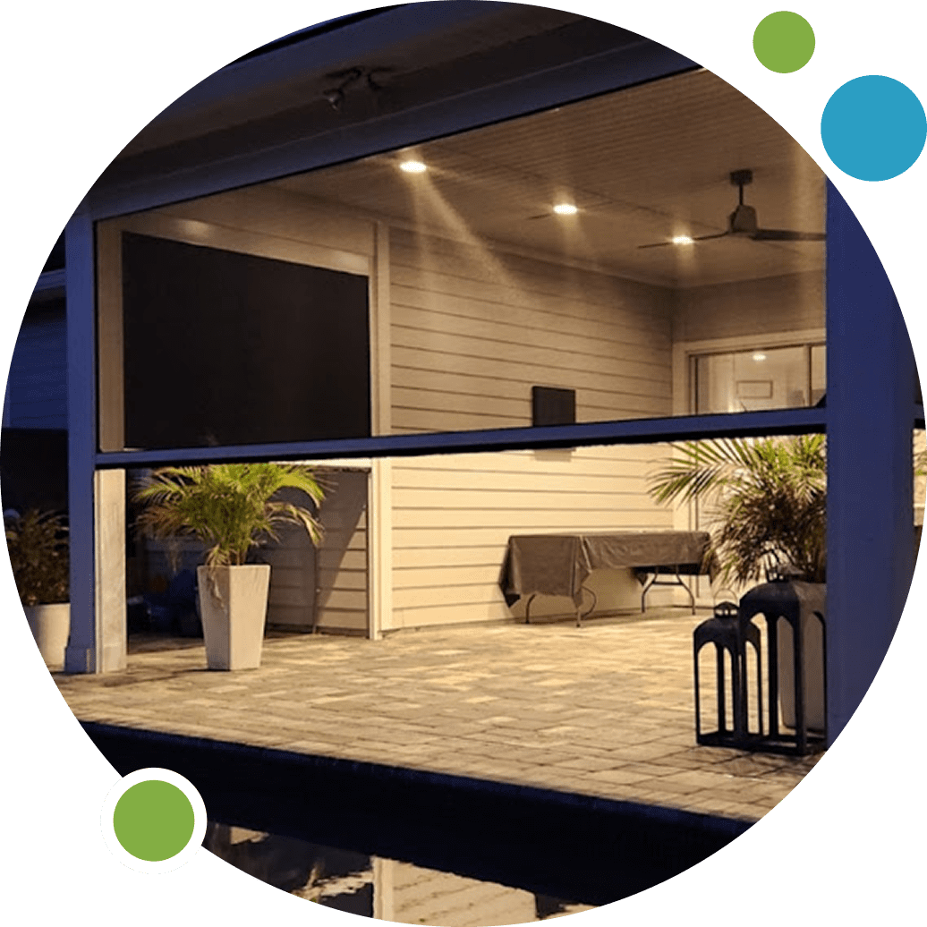 Cozy modern porch with wooden deck and seating under warm lighting.