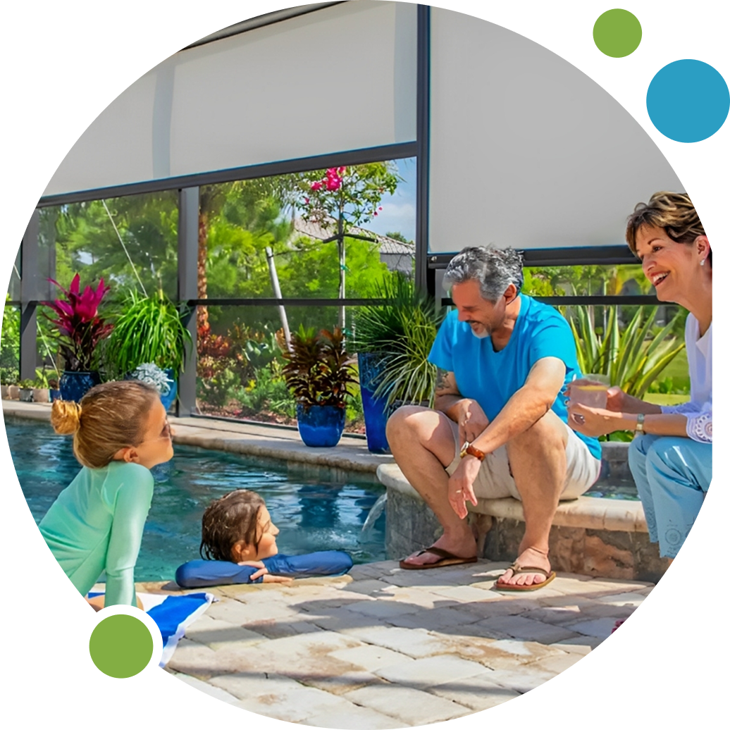 A family enjoys a sunny day by the pool with two kids and two adults relaxing.